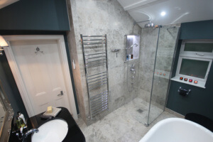 A simple and stunning walk in shower with Perrin & Rowe Traditional shower set two. Shower panel and hinged deflector from KUDOS Showers.