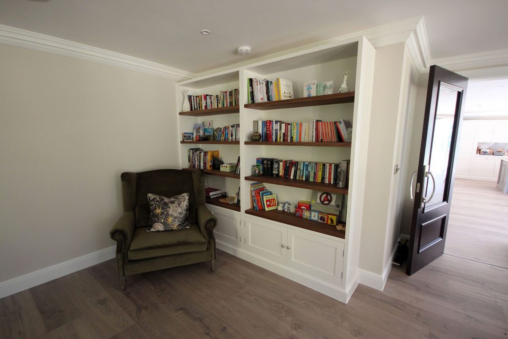 1. We made a simple open bookshelf unit with double door storage below. We love the warmth of the walnut shelving.