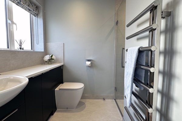 Bespoke solid wood flat fronted furniture painted Farrow & Ball 'Hague Blue'.