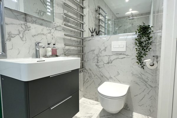 Laufen Val washbasin and two drawer vanity unit in grey compliments the tones of the room.